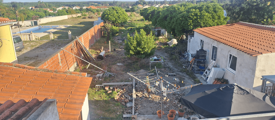 A backyard view with a pool, barbecue area, and ongoing landscaping work.