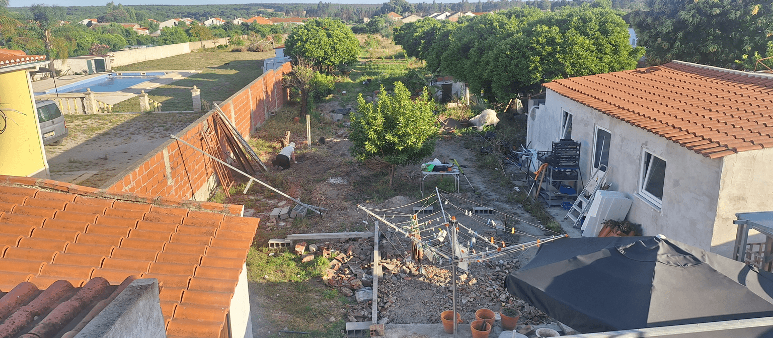 A backyard view with a pool, barbecue area, and ongoing landscaping work.