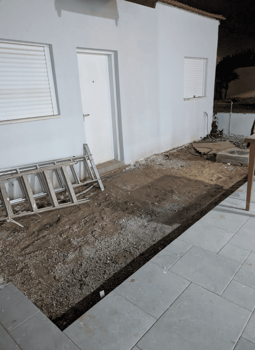 A yard area ready for planting, featuring a mix of dirt and stones.