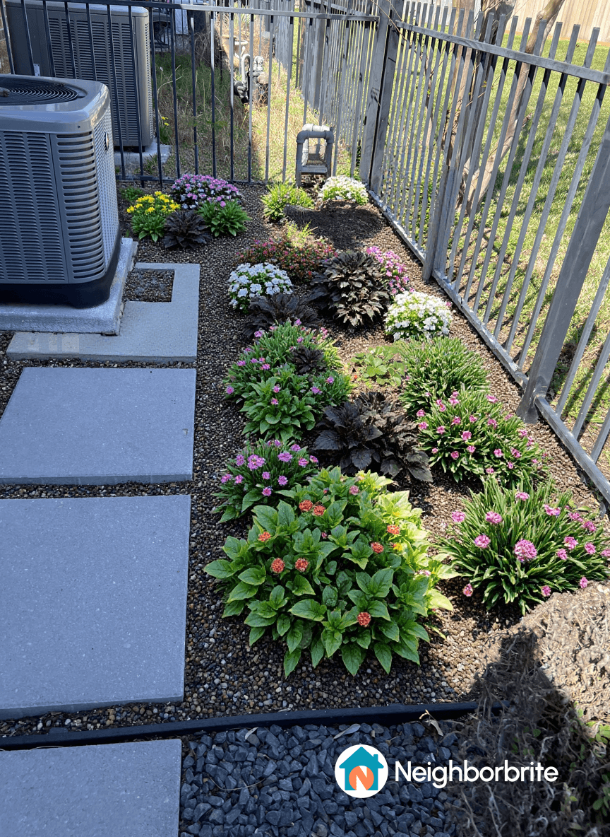 Colorful flower beds with various plants and gravel paths.