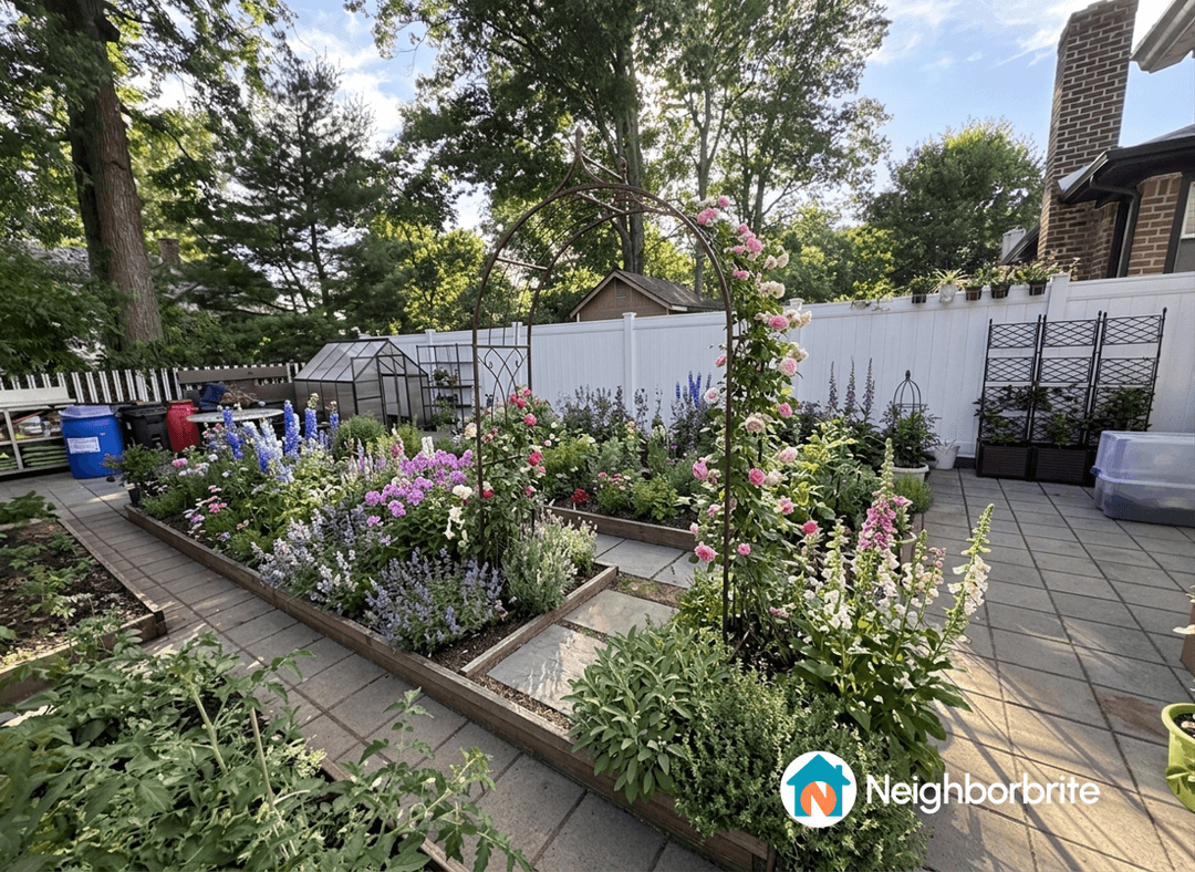 A vibrant garden featuring two arches surrounded by colorful flowers.