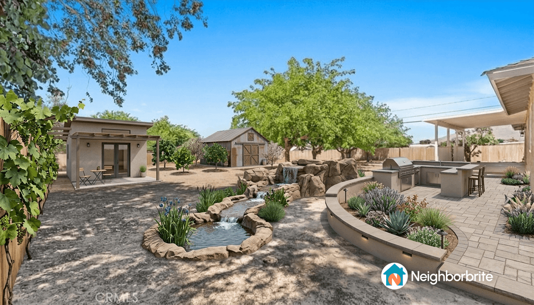 A landscaped backyard featuring a kitchen, water feature, and seating area.