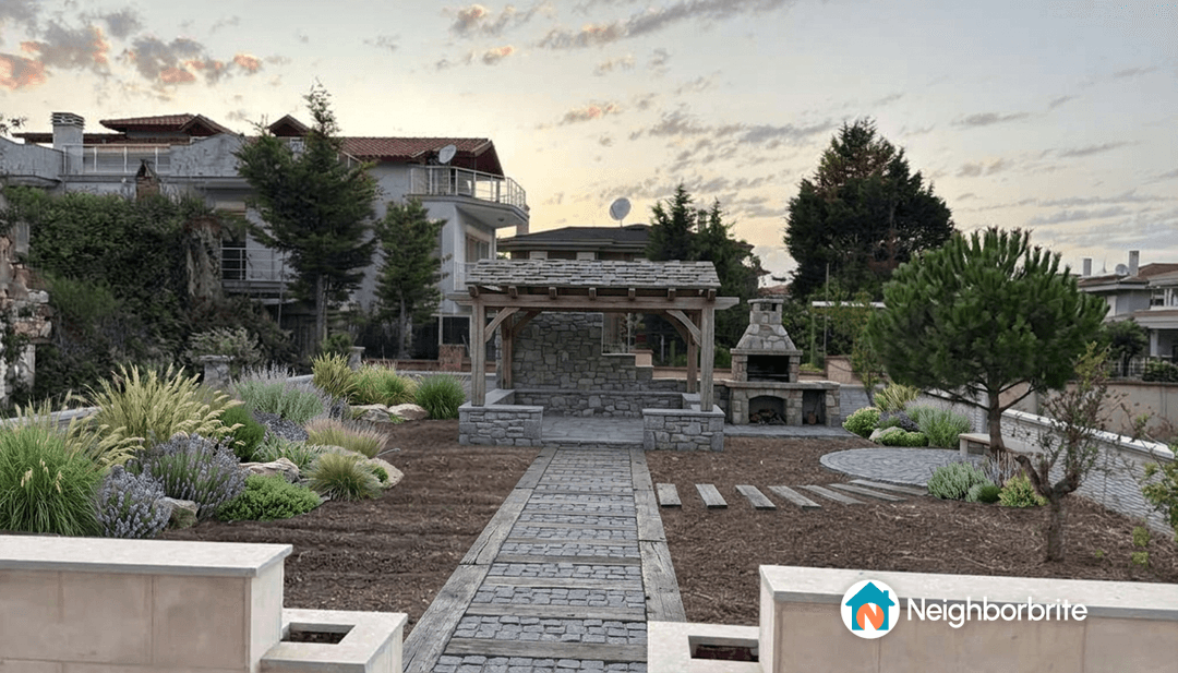 A modern garden featuring a pergola, barbecue area, and landscaped paths.
