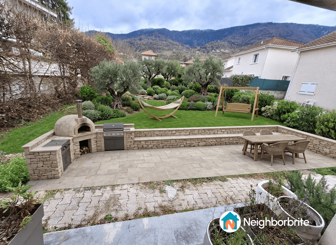 Vue d'un jardin avec espace barbecue, balançoire et verdure.