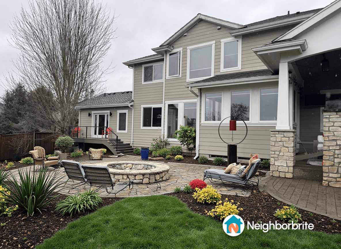 A landscaped yard with a fire pit and seating area.