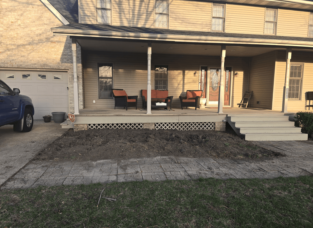 A front yard with a shaded area, featuring a porch and seating, seeking landscaping suggestions.