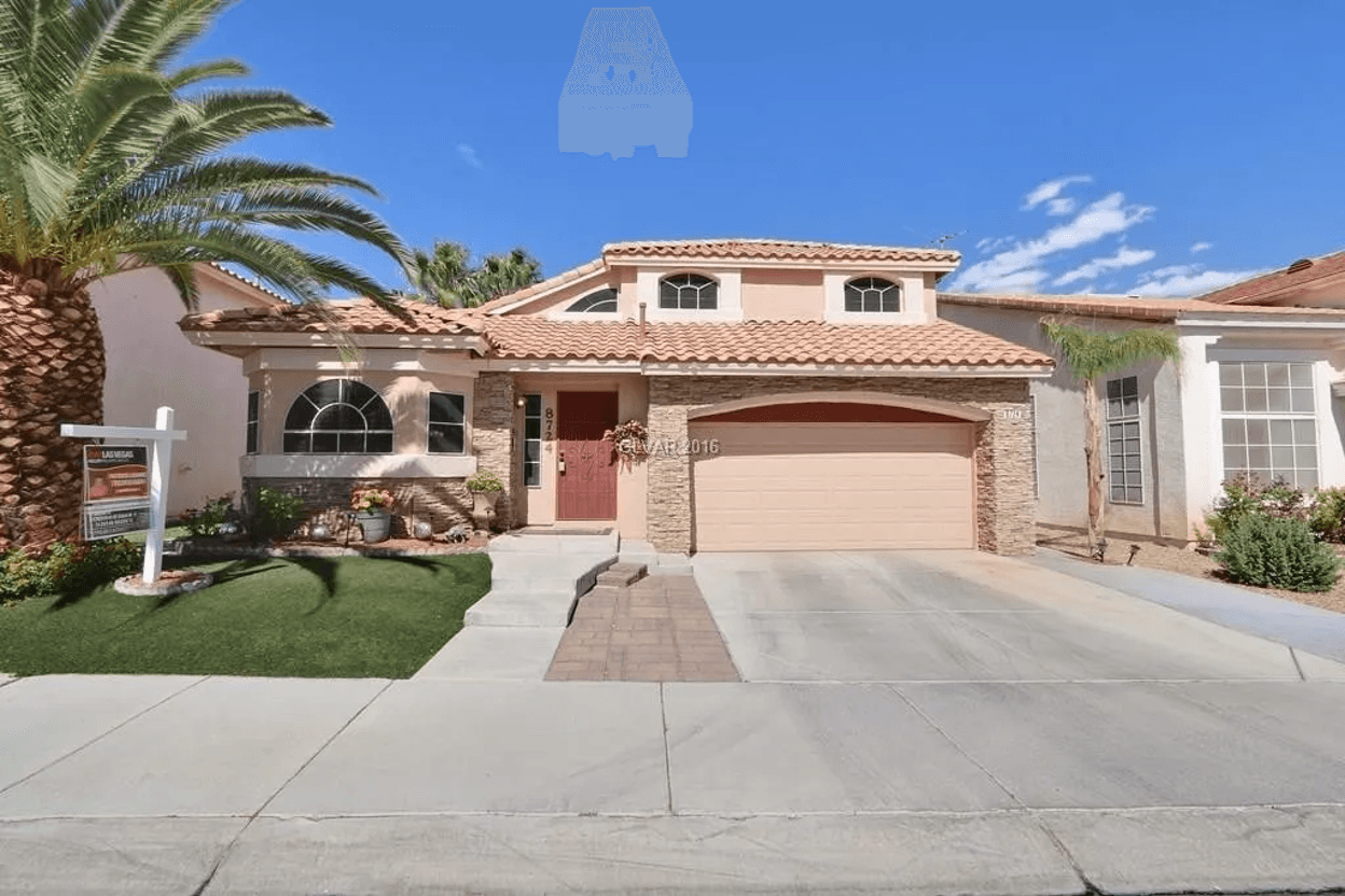 Front yard with turf, palm trees, and a house facade.