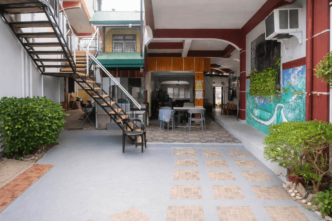 A courtyard with stairs, needing a modern pool and landscaping redesign.