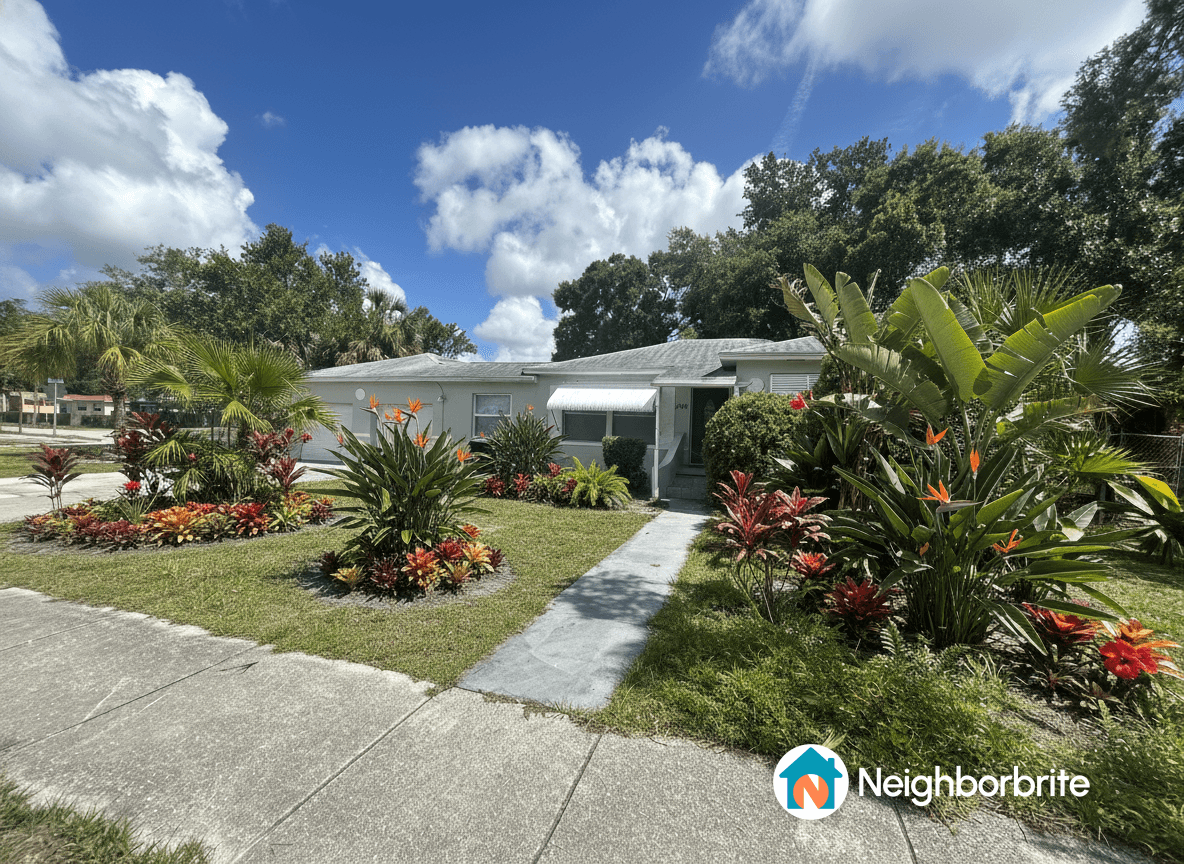 A colorful front yard with tropical plants and flowers.