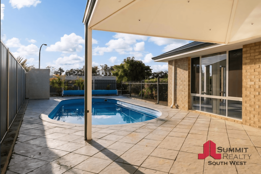 A pool area with tiled flooring, seeking paver ideas.