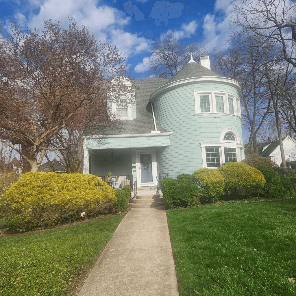 A house with large bushes being removed to enhance the porch.