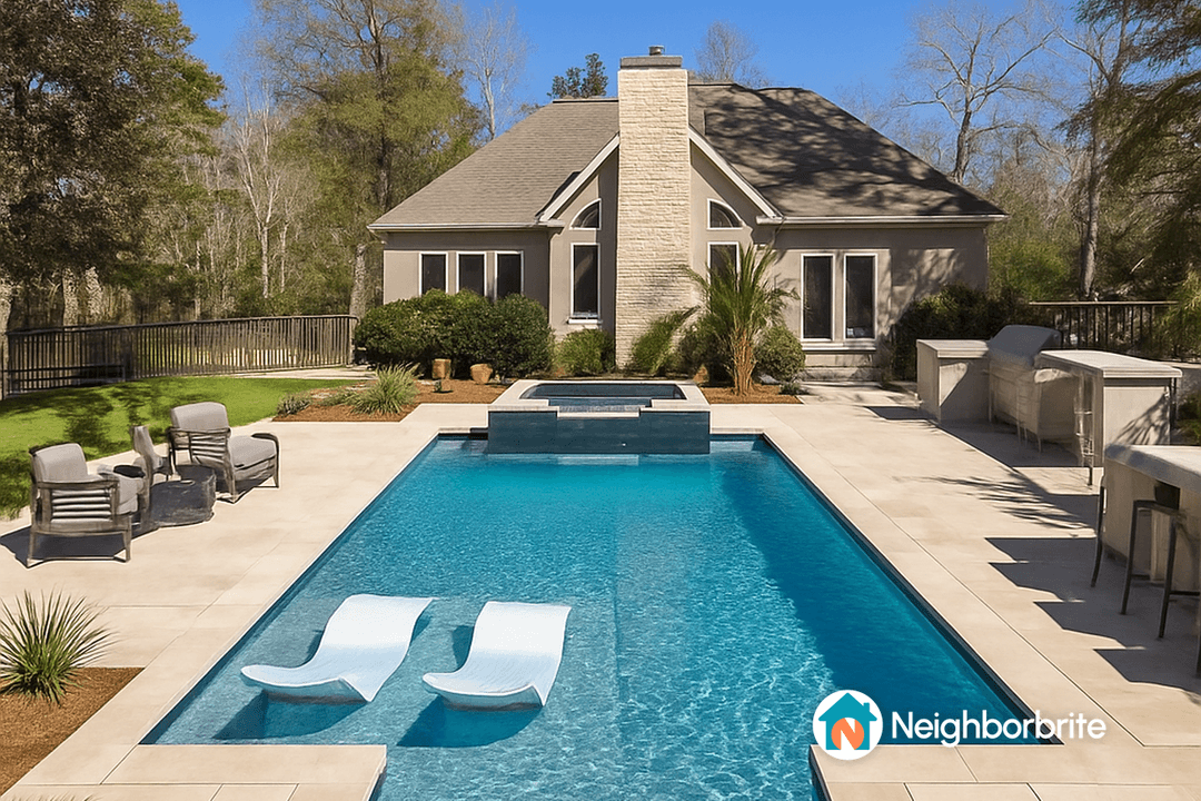 A backyard with a pool, spa, and seating area, seeking project cost advice.