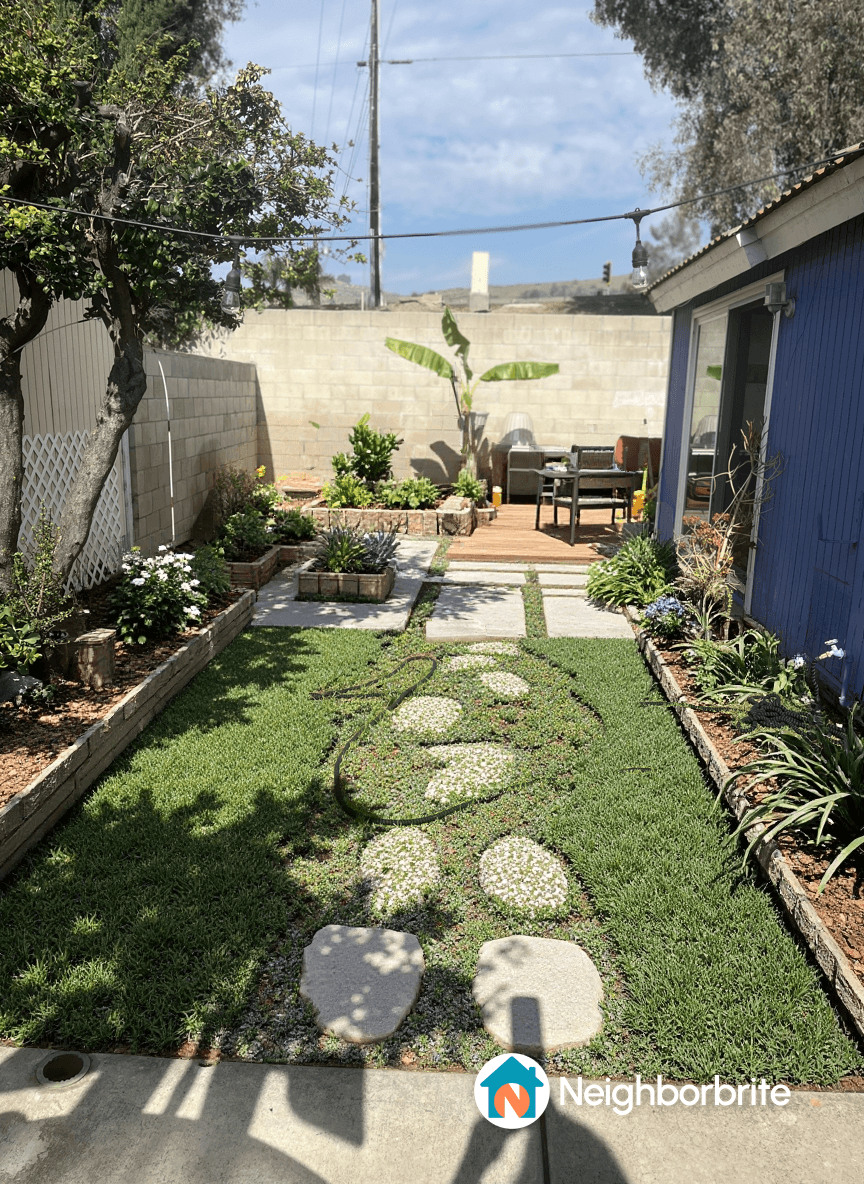 A garden with stone pathways and planters, suggesting edging design.