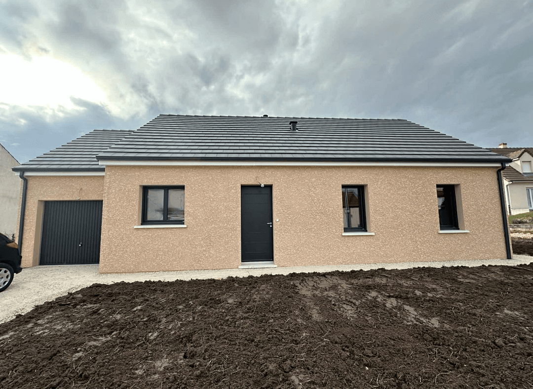 Front view of a house with a paved walkway and garden area.