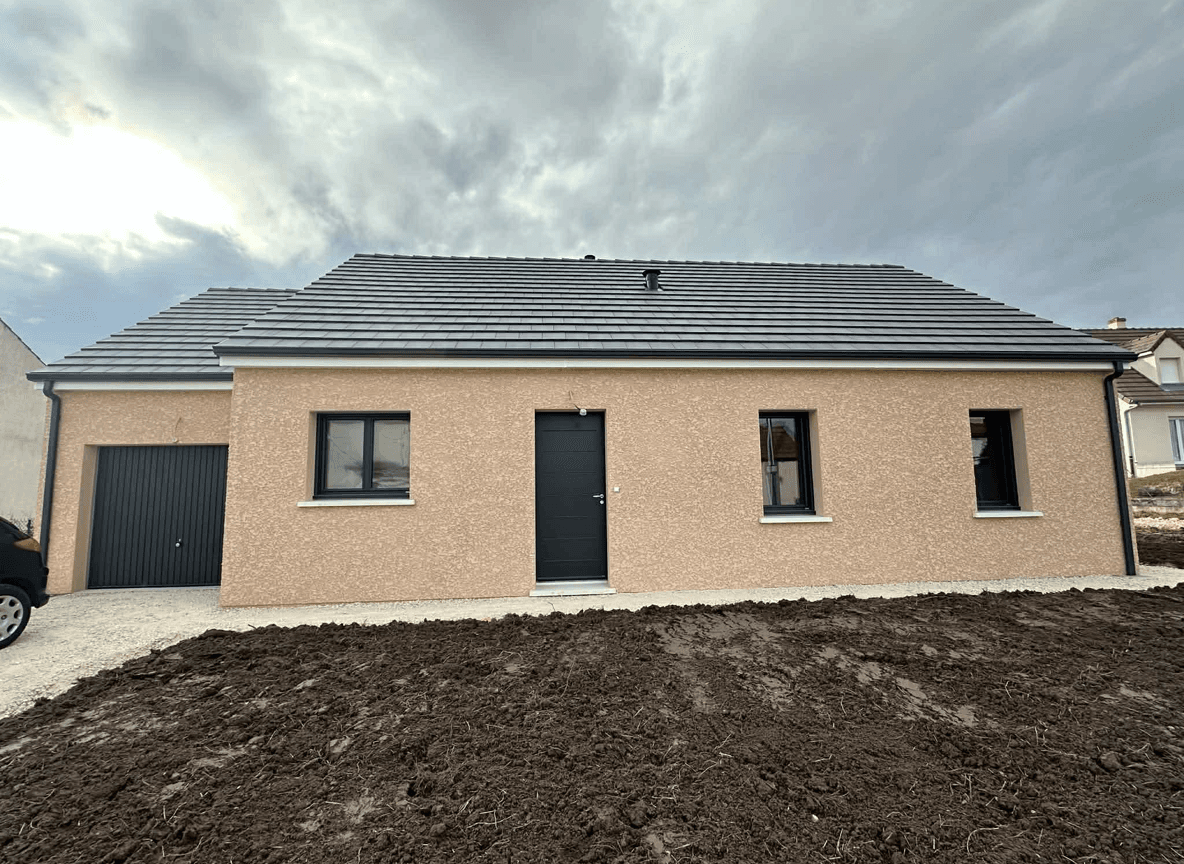 Front view of a house with a paved walkway and garden area.