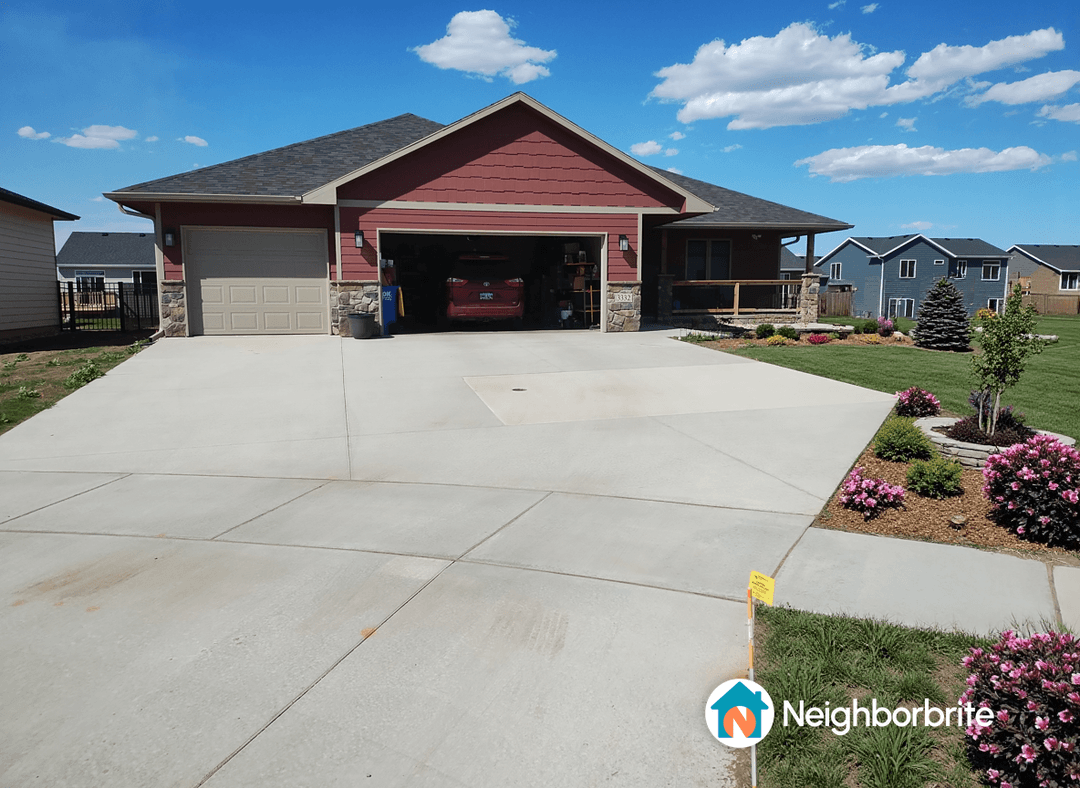 A beautiful home with a well-maintained yard and colorful flowers.
