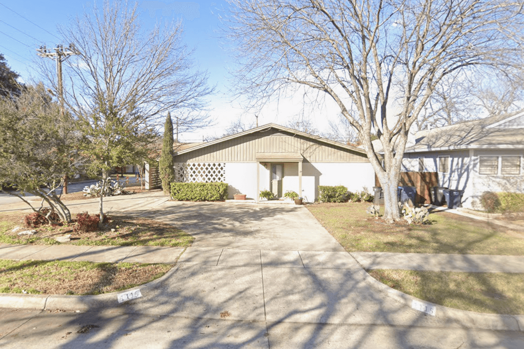 A front view of a house with a simple door and landscaping.