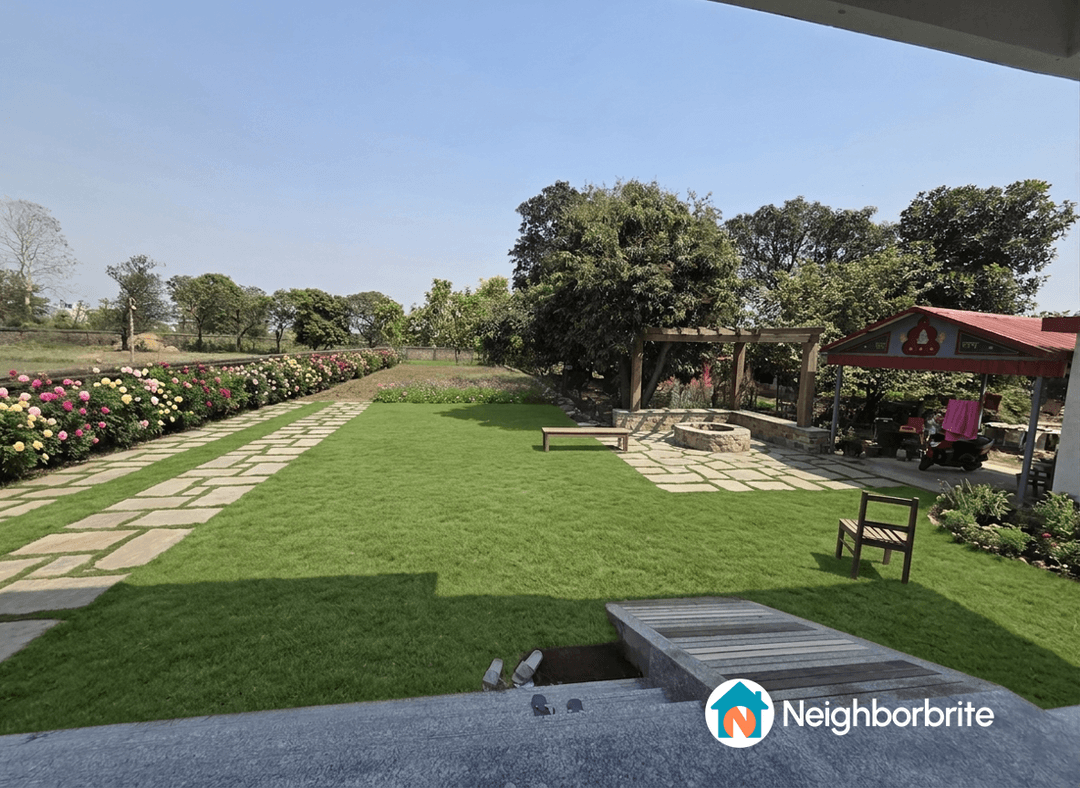 A landscaped yard with roses, a pergola, and a stone pathway.