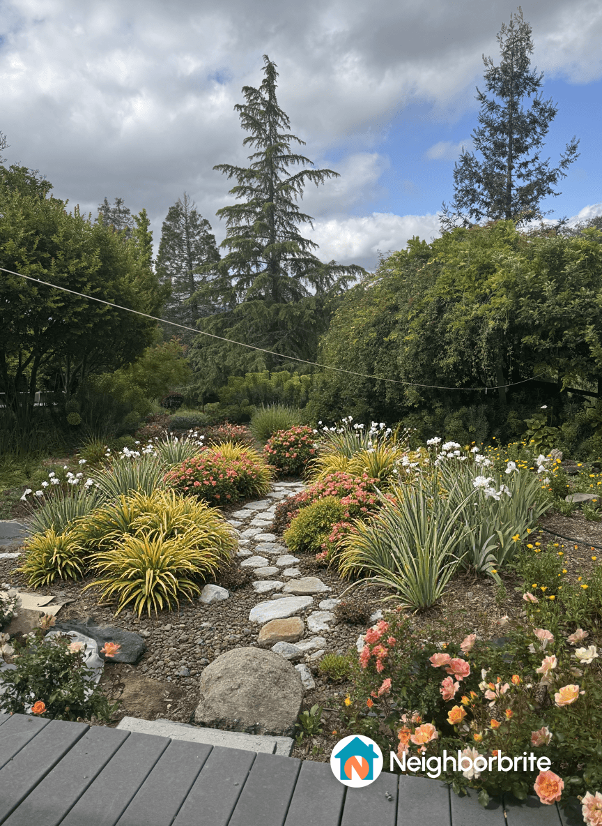 A vibrant garden path surrounded by colorful flowers and greenery.