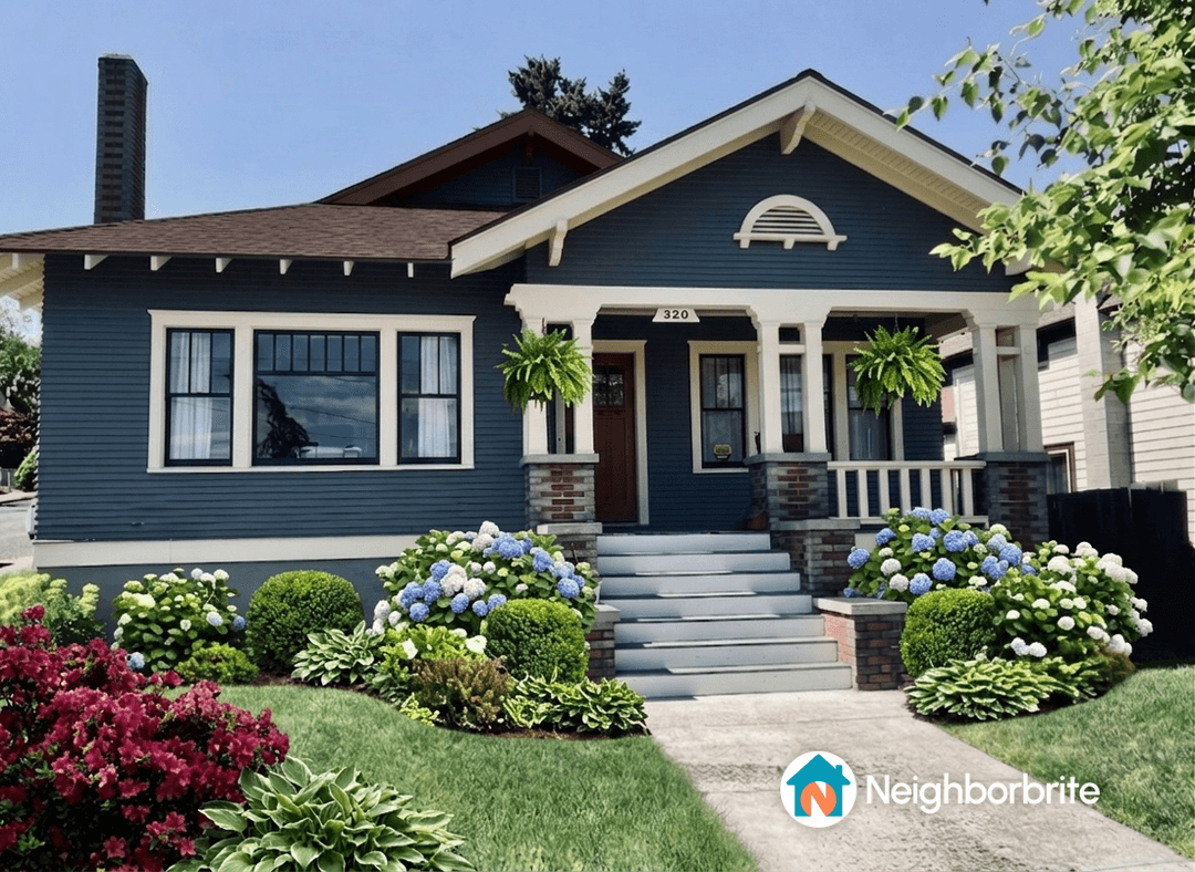 A beautiful home with hydrangeas in the garden, showcasing vibrant blooms.