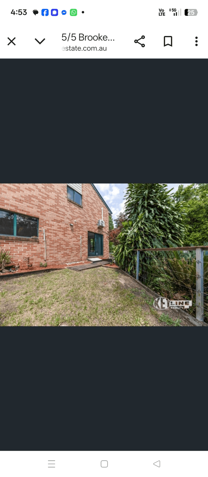 Outdoor area with grass and a brick wall, seeking pergola ideas.