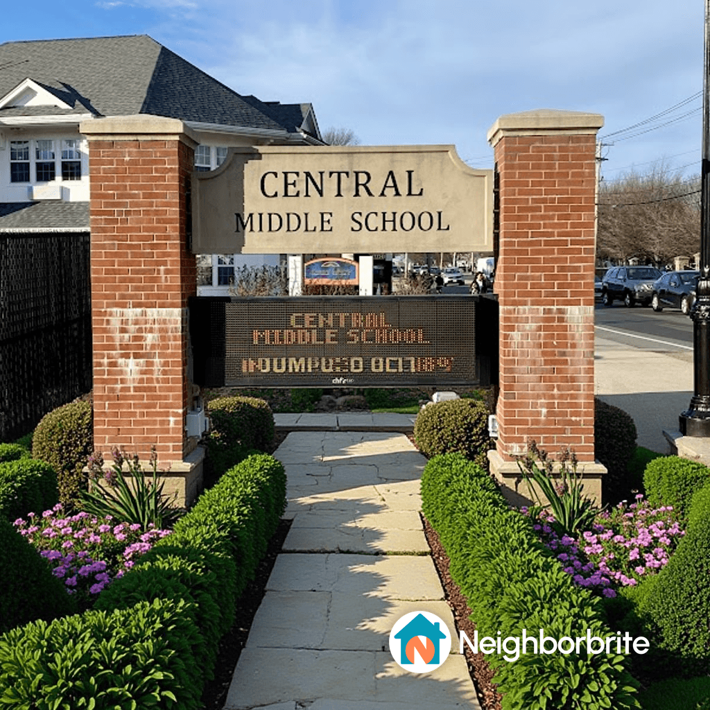 Entrance of Central Middle School with landscaped path and flowers.
