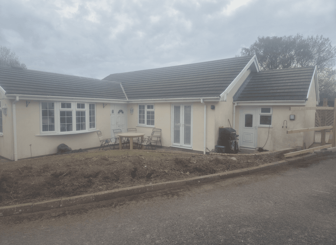 A house with a cleared yard, ready for garden development.