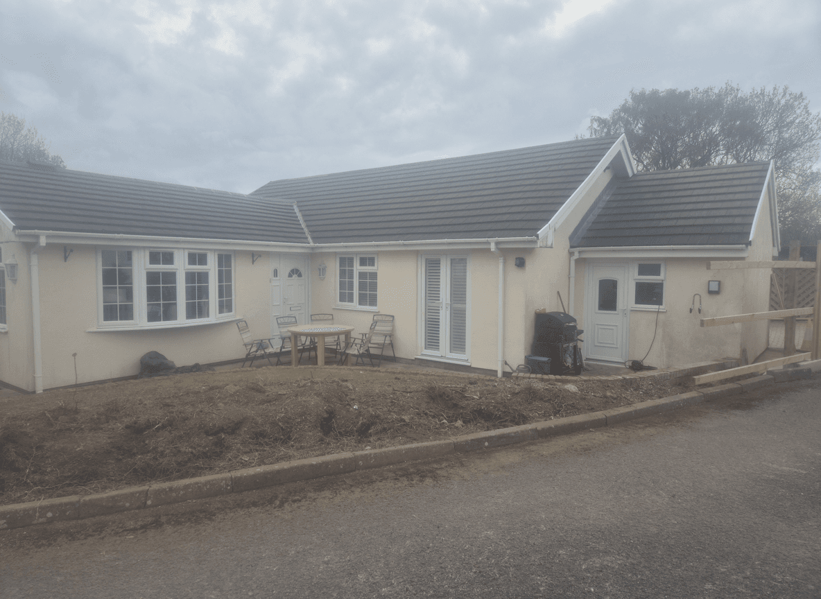 A house with a cleared yard, ready for garden development.