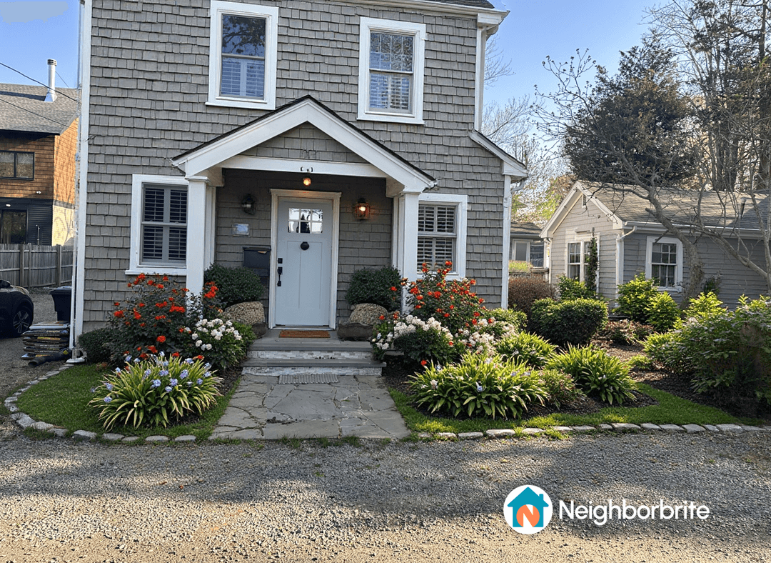 A well-maintained front yard with various flowering plants and shrubs.