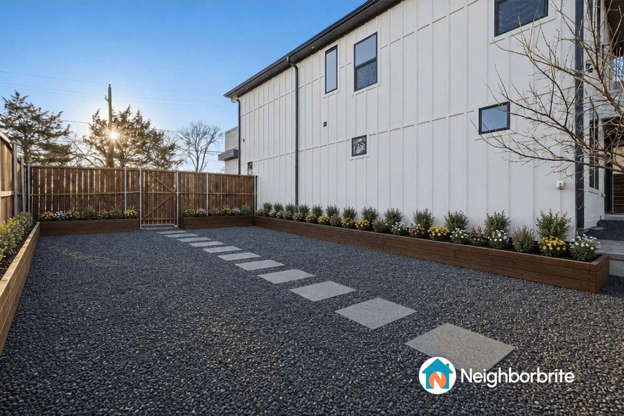 A landscaped yard with gravel, stepping stones, and flower beds.