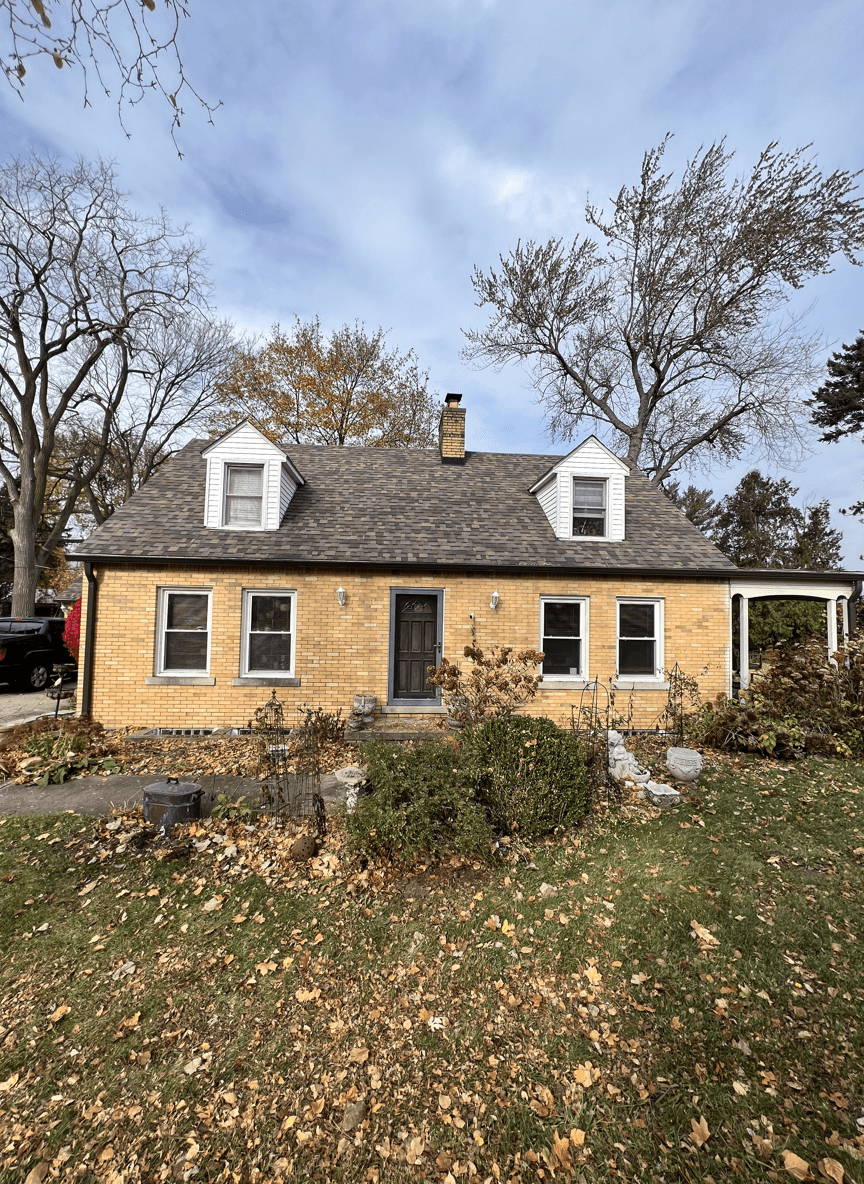 A cozy home with autumn leaves, showcasing potential Christmas light ideas.