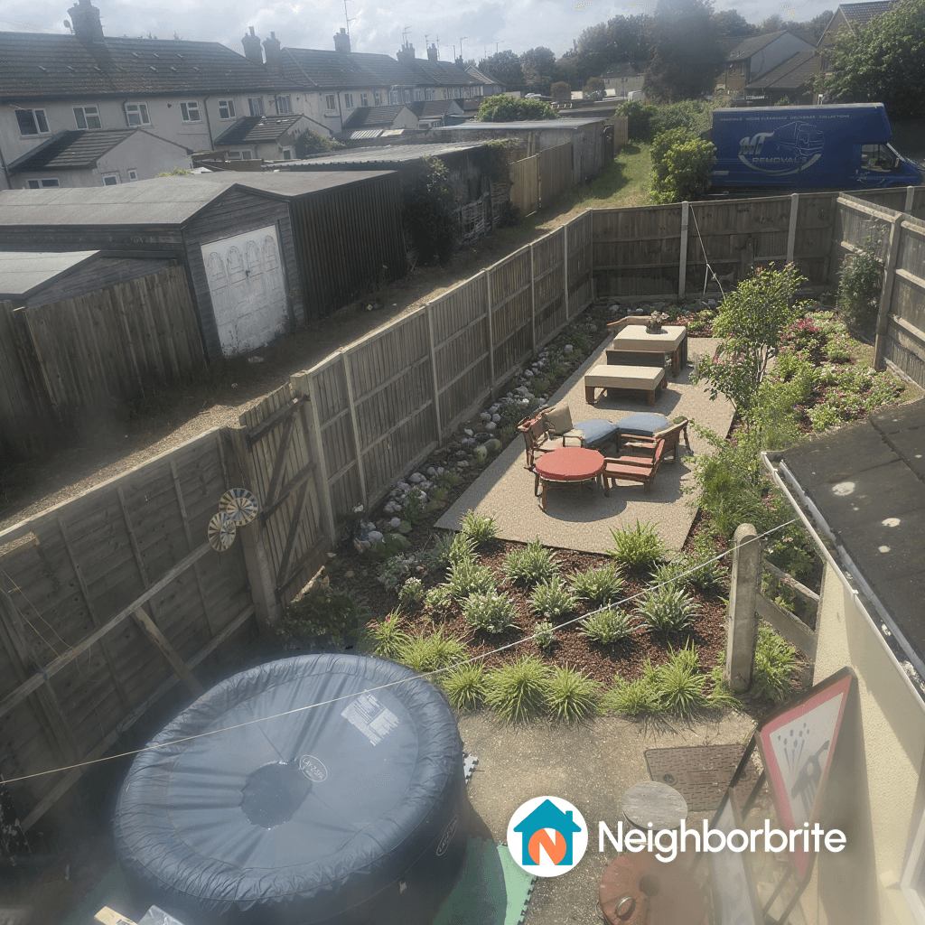 Aerial view of a landscaped backyard with seating area and garden features.