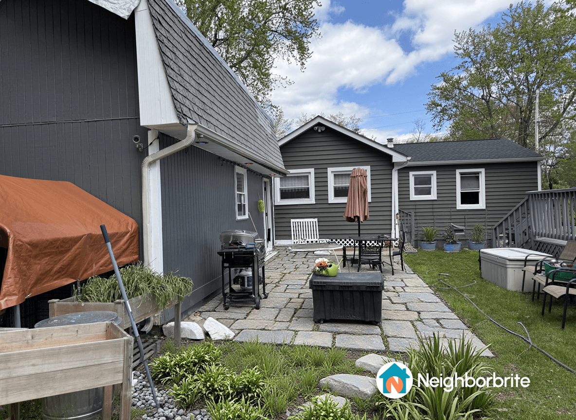 A backyard patio with potential for a gazebo, fire pit, and dining area.