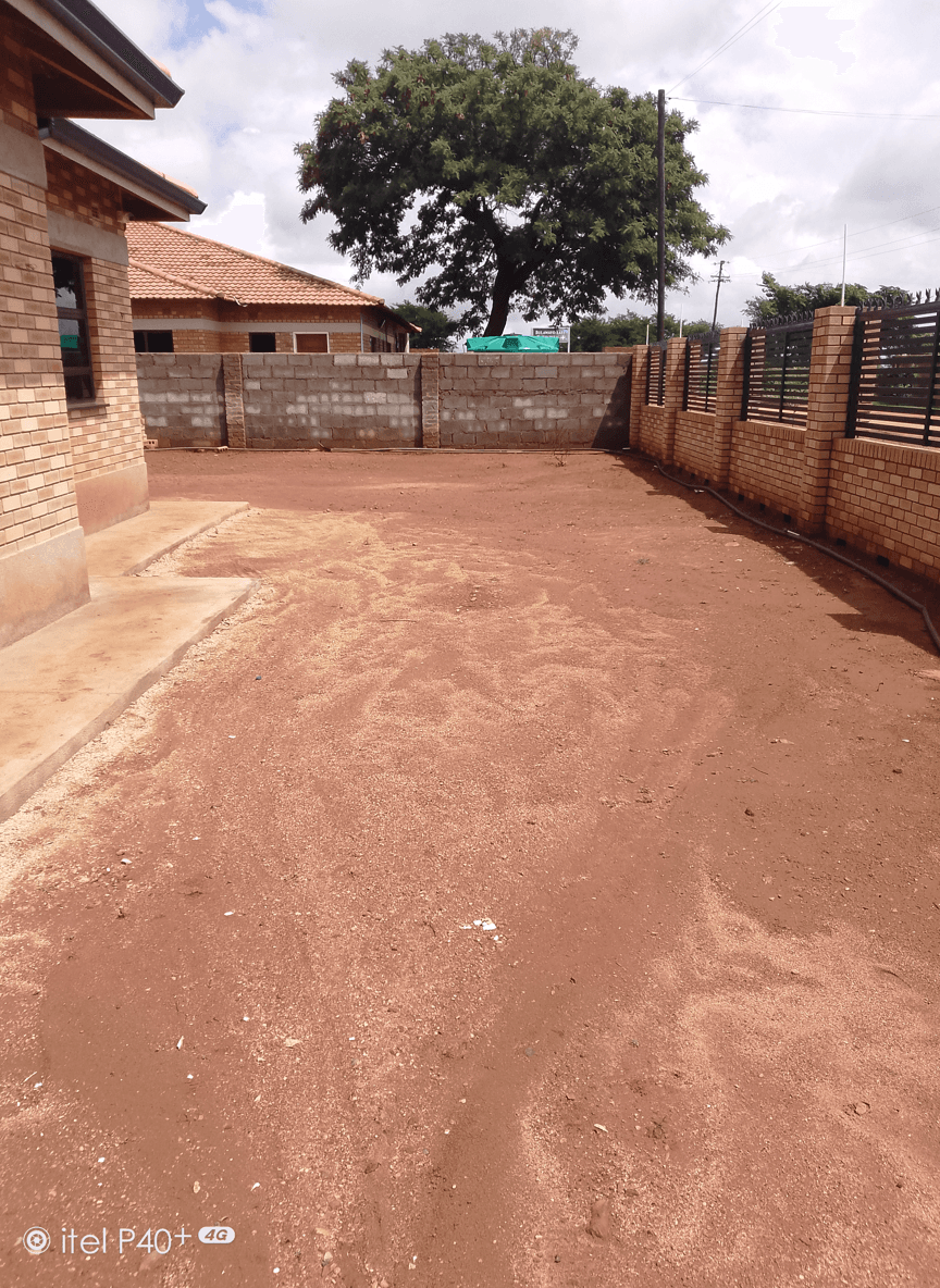 A bare area in front of a verandah, ready for lawn planting.