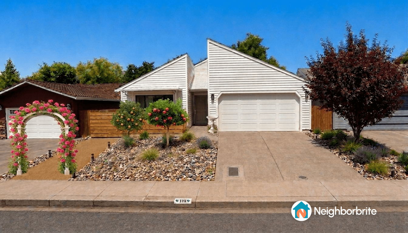 A charming home with a floral arch, orange trees, and landscaped stones.