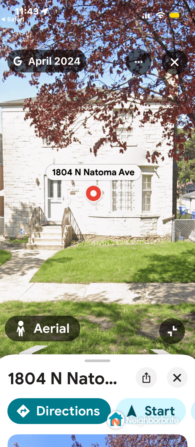 Aerial view of a front lawn with grass and steps leading to a house.