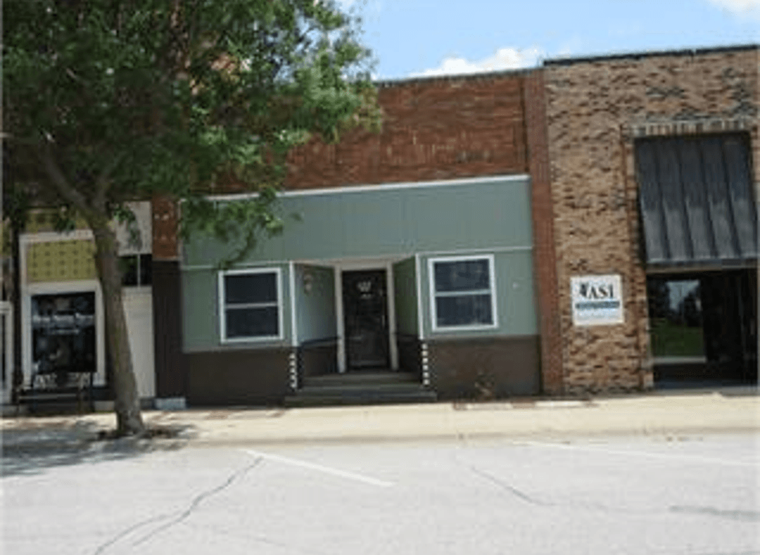A building with green paint and brick; suggestions to change colors.