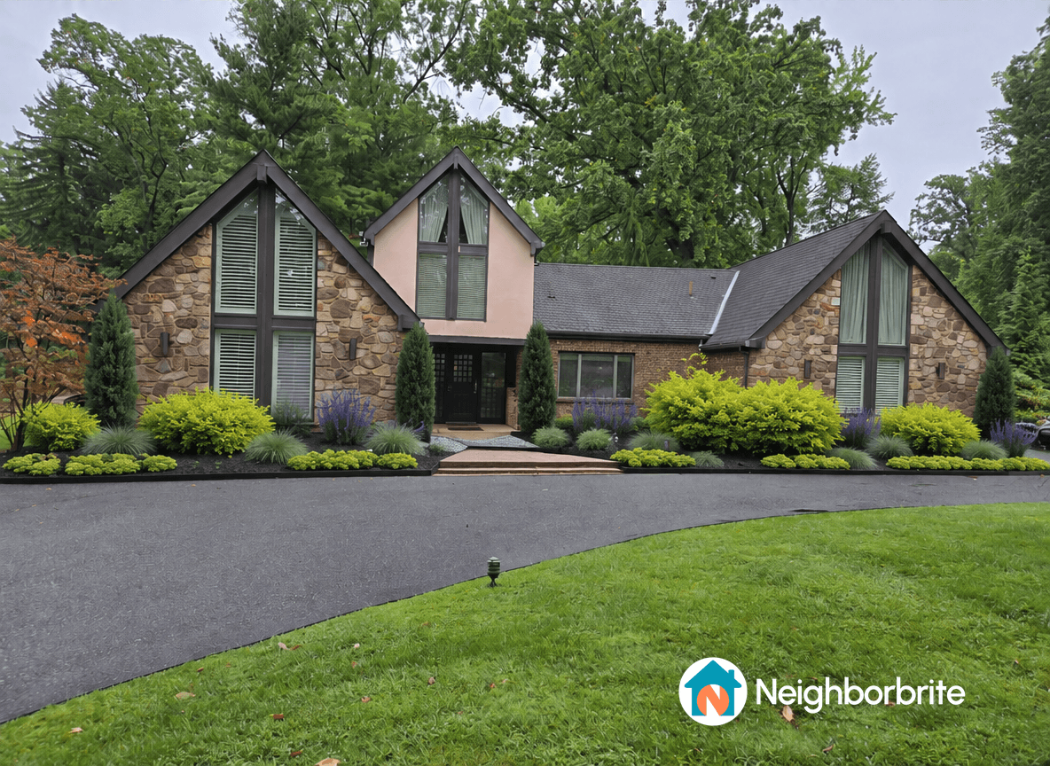 A beautiful home with stone exterior and lush landscaping.