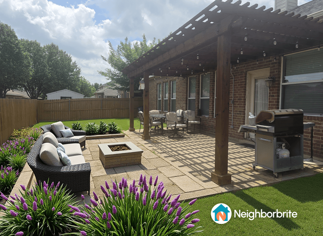 A renovated patio with seating, plants, and a grill.