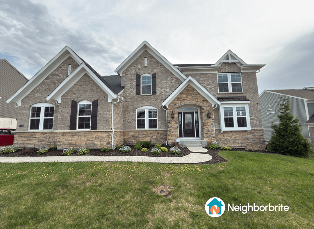 A house with a landscaped front yard, seeking plant suggestions.