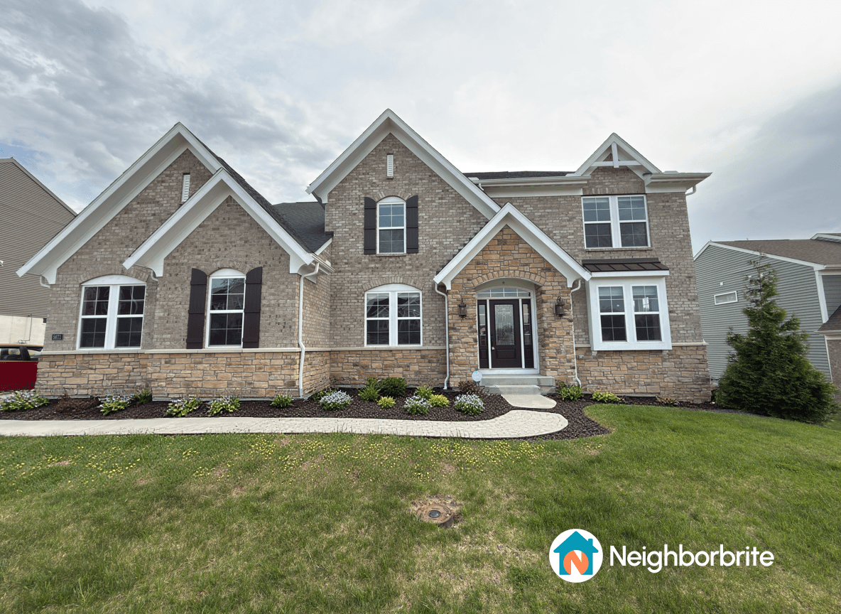 A house with a landscaped front yard, seeking plant suggestions.