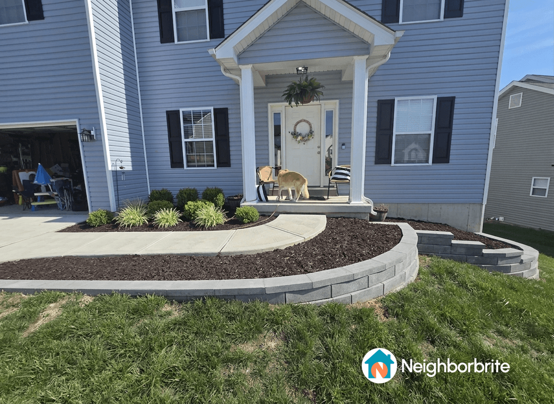Front yard with a proposed retaining wall and mulch bed.
