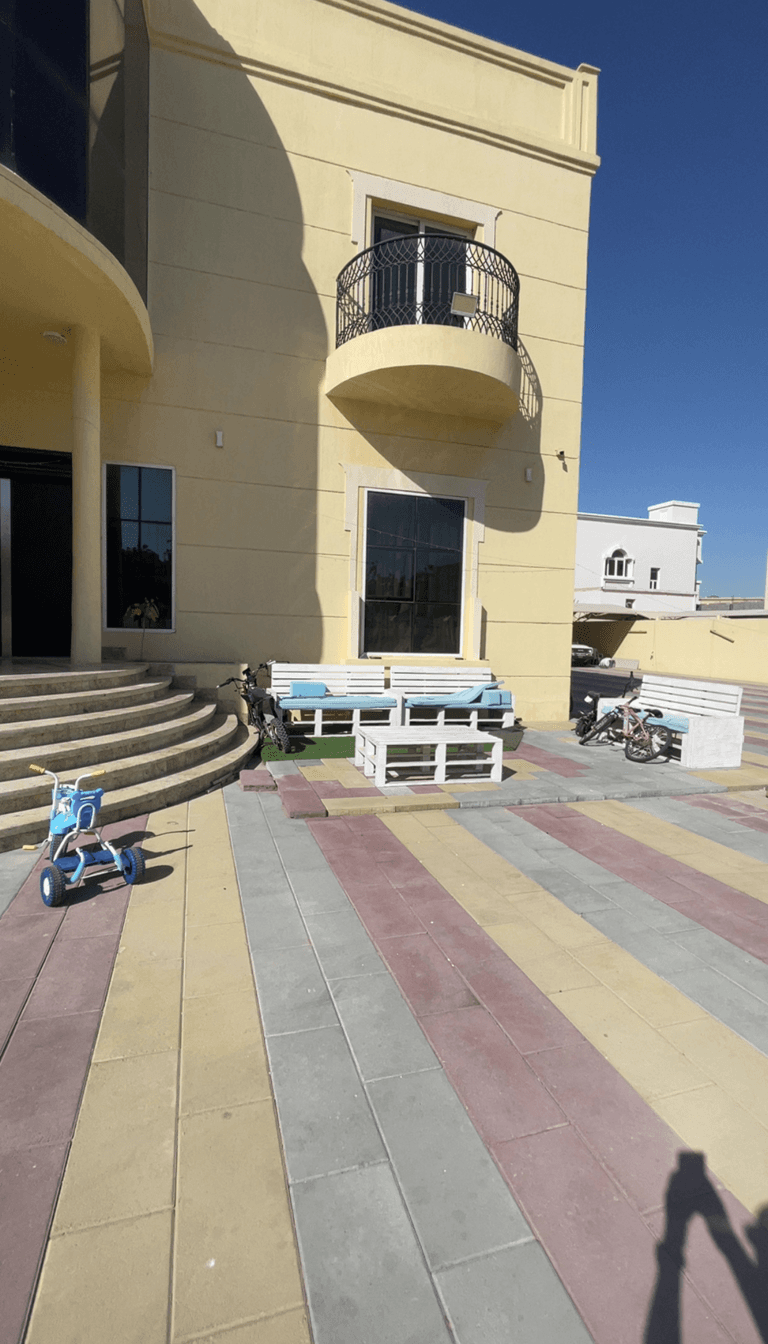 Exterior view of a house with a playroom area and garden access.