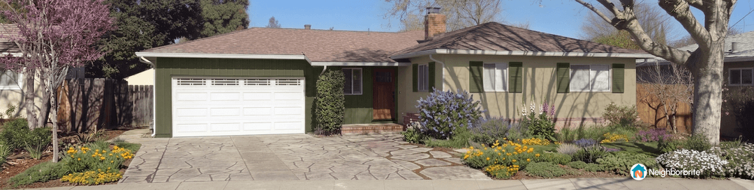 A vibrant front yard with flowers and a well-maintained house.