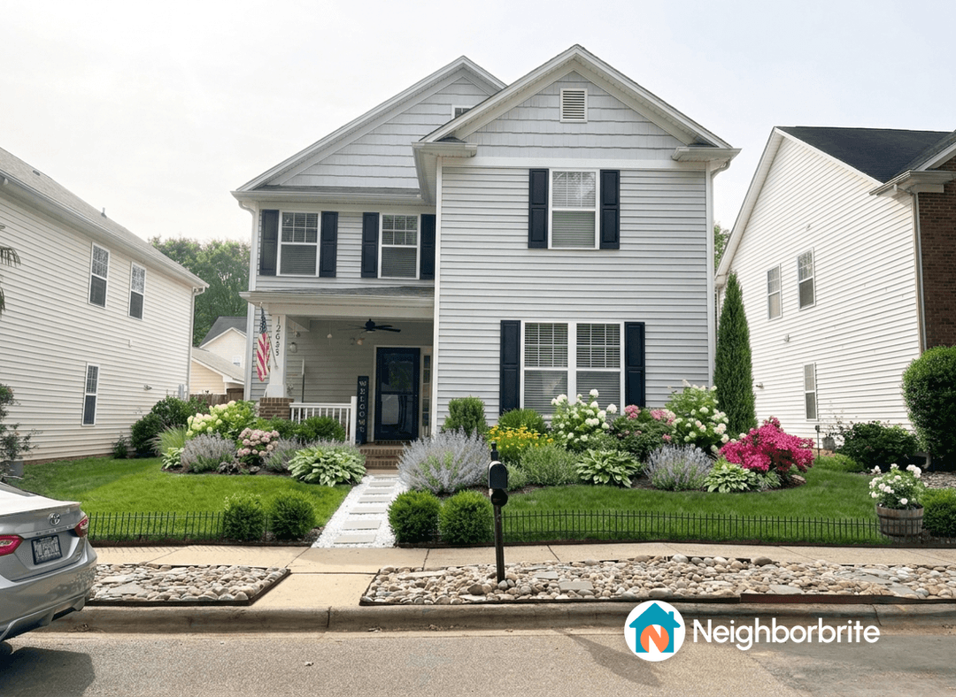 Front yard with numerous shrubs and flowers, seeking simplification advice.