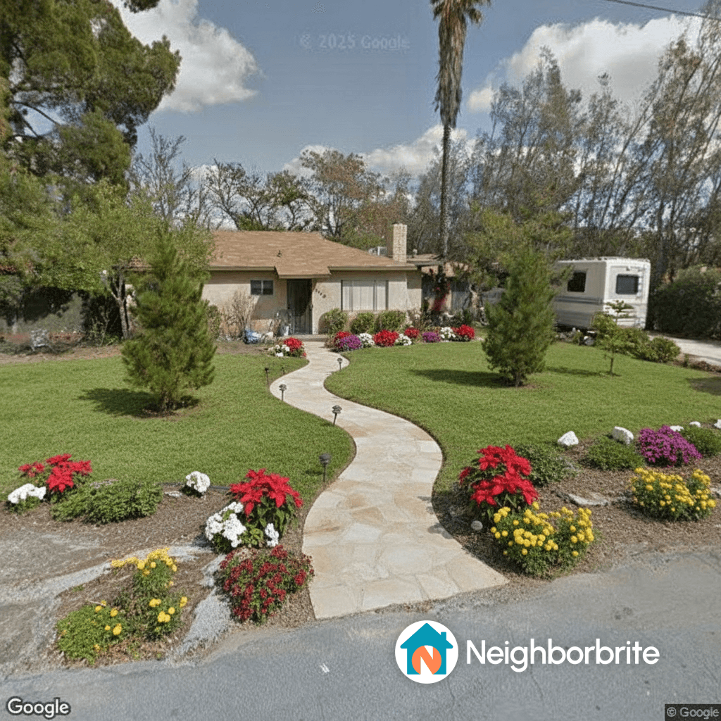 A well-maintained yard with a winding path and colorful flowers.