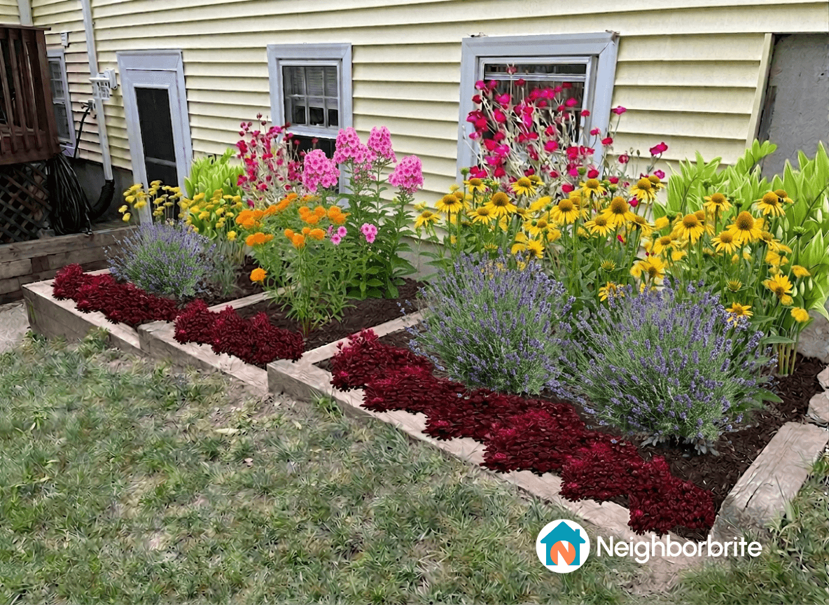 Vibrant pollinator garden with colorful flowers and new wood ties.