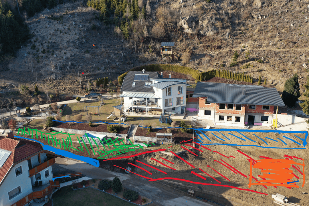 Aerial view of a yard with color-coded areas: blue for wall, green for grass, orange for parking.