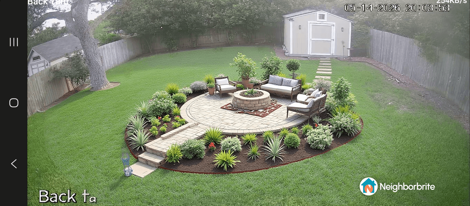 A landscaped backyard with seating area and plants.