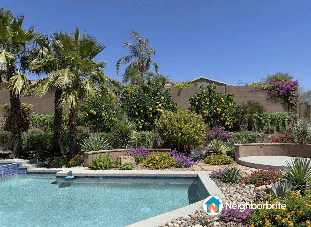 A pool area with lush landscaping, seeking a walking path.